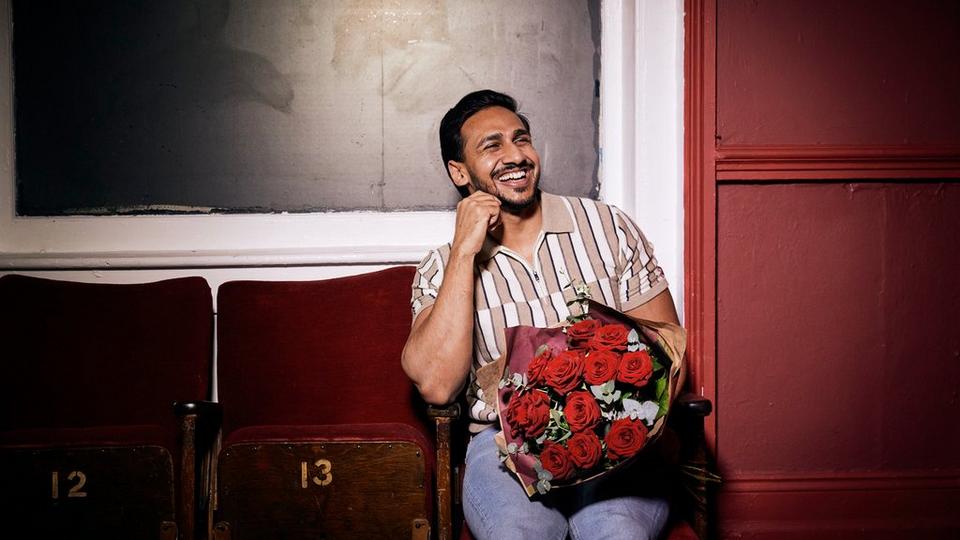 Man with red roses smiling