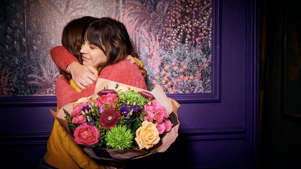 Women gifting flowers