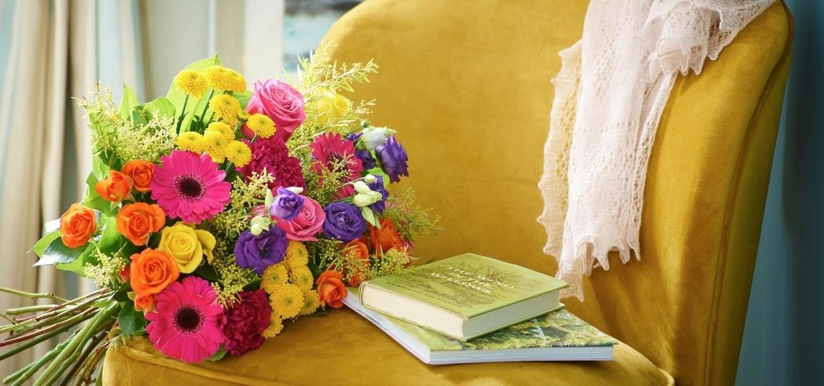 bright-bouquet-on-armchair-with-books