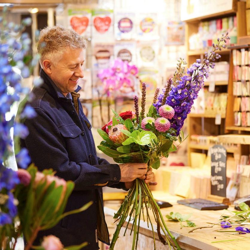 local-florist-arranging-flower-bouquet-purple-home