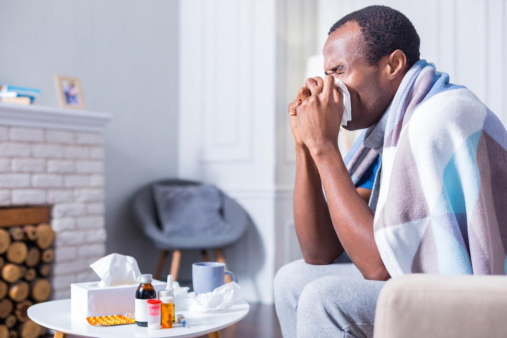 man-blowing-his-nose-unwell