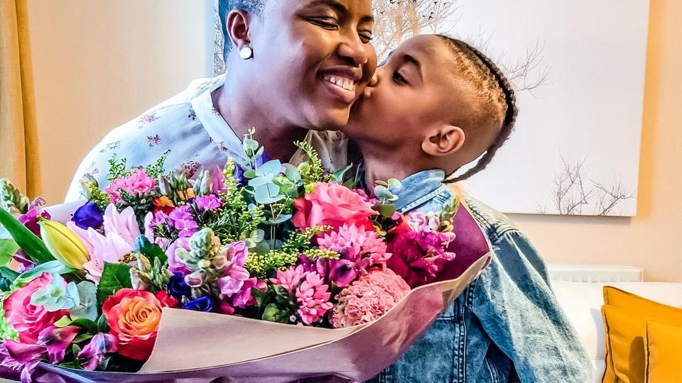 recipient-receiving-bouquet-and-kiss-from-child