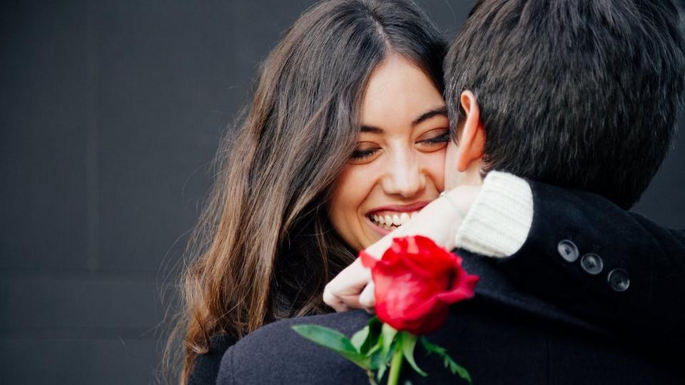 woman-hugging-man-with-rose