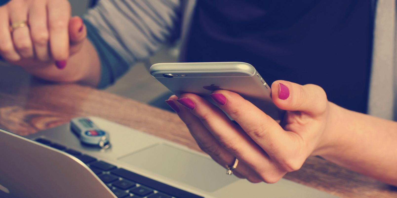 women-making-a-booking-on-phone-stock
